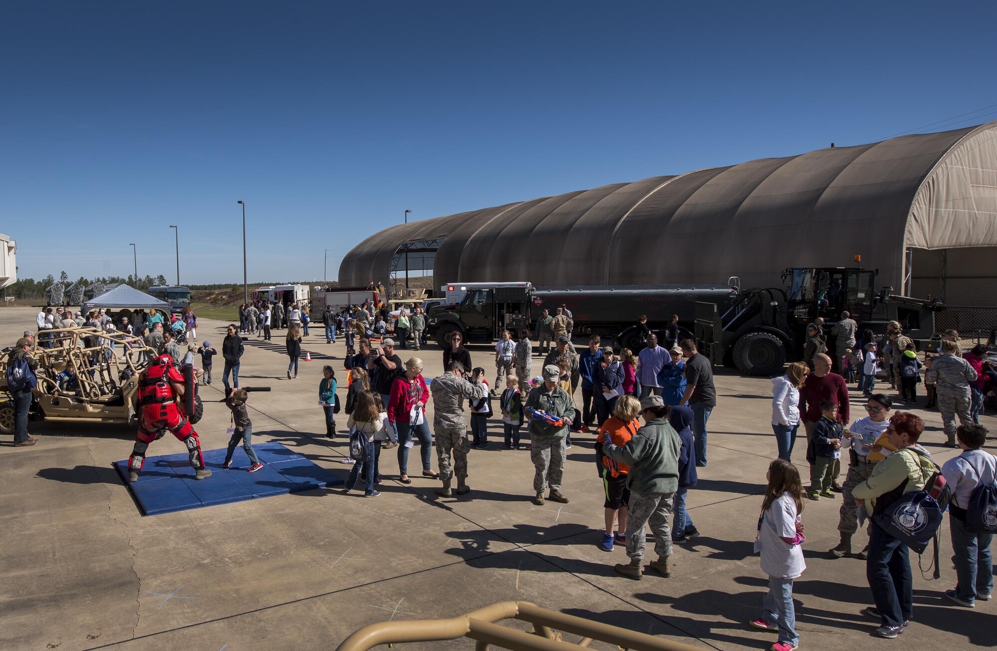 The side of the MADD building became a busy deployed location as part of the 919th Special Operations Wing’s Operation Hero event at Duke Field, Fla., March 4.  The wing held a mock deployment for the Reserve children to include a deployment line, simulated flight and a “down range” location with games and displays.  (U.S. Air Force photo/Samuel King Jr.)