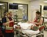 Maj. Cari Matthews, a physician with the Montana Air National Guard, evaluates a patient while Kristi Thompson, a nurse from the Great Falls Clinic, completes a chart Feb. 16, 2017, during a mass casualty exercise at the Noble Training Center at the Federal Emergency Management Agency’s Center for Domestic Preparedness in Anniston, Alabama. The emergency department staff was challenged with overwhelming numbers of patients following a simulated terrorist attack.  (US Air National Guard photo/Staff Sgt. Lindsey Soulsby)