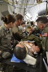 Air Force and Army medics stabilize a simulated patient connected to an extracorporeal membrane oxygenation machine (ECMO) upon boarding a C-17 Globemaster III for transport from Patrick Air Force Base, Florida, March 4, 2017 as part of the 5th annual MEDBEACH joint medical response exercise. ECMO is a treatment that uses a pump to circulate blood through an artificial lung back into the bloodstream of a patient. (U.S. Air Force photo/Tech. Sgt. Lindsey Maurice)