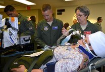 Col. Sandra Dickerson of the 302nd Aeromedical Staging Squadron discusses the care of a simulated patient with Capt. Travis Bice, 920th ASTS critical care air transport team nurse, before heading out to a C-17 Globemaster III for transport during the 5th annual MEDBEACH joint medical response exercise March 4, 2017 at Patrick Air Force Base, Florida. (U.S. Air Force photo/Tech. Sgt. Lindsey Maurice)