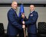 (Left) Col. Michael Remualdo, acting 927th Operations Group commander, passes the 63rd Air refueling Squadron guidon to Lt. Col. Shane Rogers during an assumption of command ceremony here March 5, 2017. (U.S. Air Force photo/Tech. Sgt. Peter Dean)