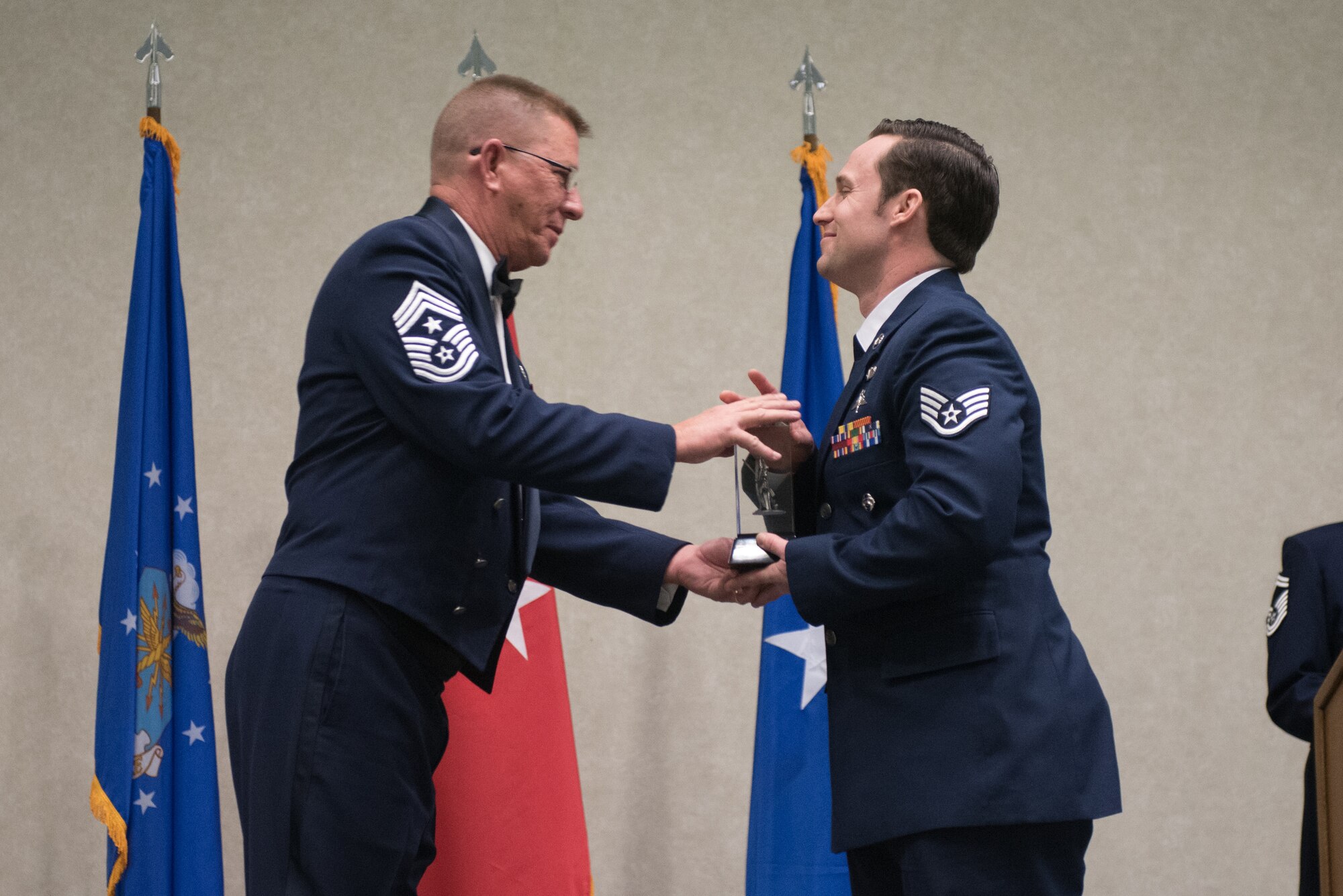Staff Sgt. Daniel Keller, a combat controller for the 123rd Special Tactics Squadron, receives the Kentucky Enlisted Exceptional Performance Award from Chief Master Sgt. Jeff Moore, Kentucky’s state command chief, during the Soldier and Airman of the Year banquet at the Kentucky Fair and Exposition Center, Louisville, Ky. on March 4, 2017. The winners were selected for their leadership and performance in their primary duties, dedication to self-improvement, and base and community involvement. (U.S. Air National Guard photo by Staff Sgt. Joshua Horton)
