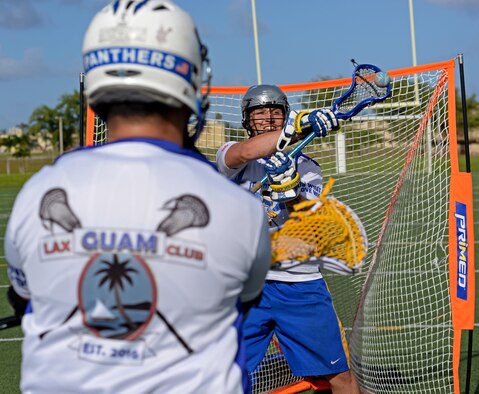 U.S. Navy Seaman Benton Lamendola, a member of the Guam Black Tips Lacrosse team, practices goalie drills Jan. 8, 2016, at Andersen Air Force Base, Guam. The Guam Black Tips lacrosse team has brought together service members from different branches to train and play lacrosse. Lamendola is a hull maintenance technician fireman in the repair department of the U.S.S Emory S. Land. (U.S. Air Force photo by Airman 1st Class Gerald R. Willis)