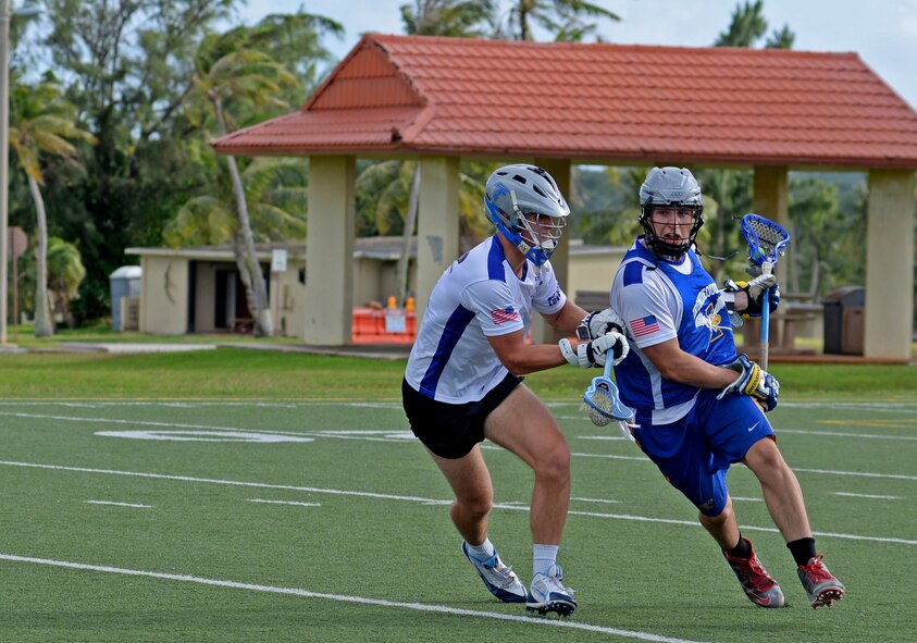 U.S. Air Force Airman 1st Class Ryan Muller, left, a member of the Guam Black Tips Lacrosse team, plays defense against Navy Seaman Benton Lamendola, right, during a scrimmage Jan. 8, 2016, at Andersen Air Force Base, Guam. The Guam Black Tips lacrosse team has brought together service members from different branches and civilians to train and play lacrosse. (U.S. Air Force photo by Airman 1st Class Gerald R. Willis)
