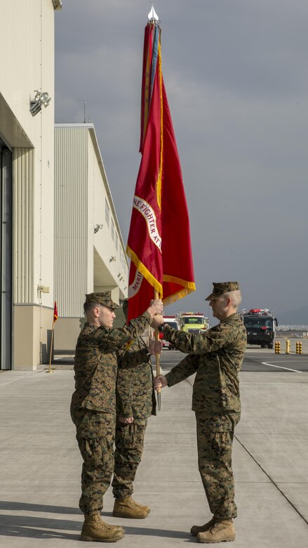 U.S. Marine Corps Sgt. Maj. Jason L. Kappen, right, Marine Fighter Attack Squadron (VMFA) 121 sergeant major, passes the squadron guidon to U.S. Marine Corps Lt. Col. J.T. Bardo, outbound VMFA-121 commanding officer, during a change of command ceremony at Marine Corps Air Station Iwakuni, Japan, March 3, 2017. The passing of the guidon symbolizes the transfer of Bardo’s role as commanding officer to U.S. Marine Corps Lt. Col. Richard M. Rusnok Jr., after serving as the squadron commander since August 2015. (U.S. Marine Corps photo by Cpl. Aaron Henson)