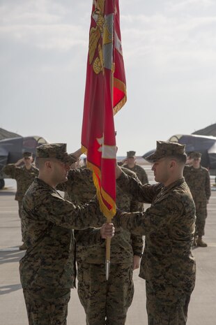 U.S. Marine Corps Lt. Col. Richard M. Rusnok Jr., oncoming commanding officer of Marine Fighter Attack Squadron (VMFA) 121, receives the VMFA-121 guidon from Lt. Col. J.T. Bardo, outgoing commanding officer of VMFA-121, on Marine Corps Air Station Iwakuni, Japan, March 3, 2017. The passing of the guidon is a Marine Corps tradition signifying the passing on of the commanding officer billet. (U.S. Marine Corps photo by Lance Cpl. Jacob A. Farbo)