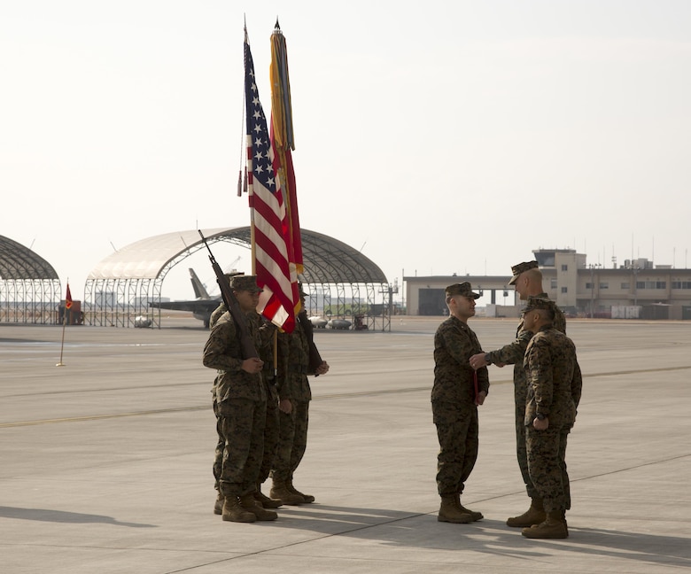 Marines, Sailors and civilian personnel gather on Marine Corps Air Station Iwakuni, Japan, to observe a change of command ceremony for Marine Fighter Attack Squadron (VMFA) 121, March 3, 2017.  Lt. Col. J.T. Bardo, outgoing commanding officer of VMFA-121, led the squadron during their move from Marine Corps Air Station Mirimar, California to MCAS Iwakuni and transferred the command to Lt. Col. Richard M. Rusnok Jr. (U.S. Marine Corps photo by Lance Cpl. Jacob A. Farbo)