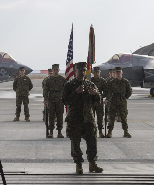 Marines, Sailors and civilian personnel gather on Marine Corps Air Station Iwakuni, Japan, to observe a change of command ceremony for Marine Fighter Attack Squadron (VMFA) 121, March 3, 2017.  Lt. Col. J.T. Bardo, outgoing commanding officer of VMFA-121, led the squadron during their move from Marine Corps Air Station Mirimar, California to MCAS Iwakuni and transferred the command to Lt. Col. Richard M. Rusnok Jr. (U.S. Marine Corps photo by Lance Cpl. Jacob A. Farbo)