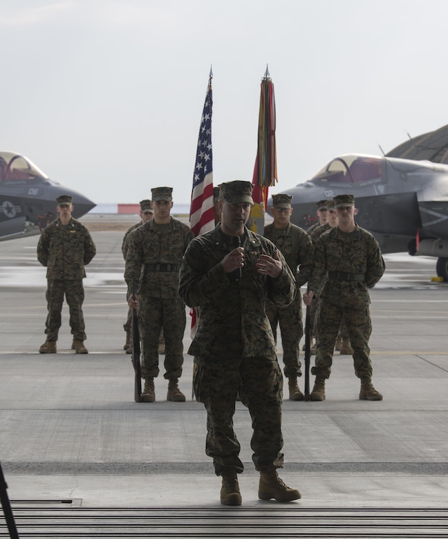 Marines, Sailors and civilian personnel gather on Marine Corps Air Station Iwakuni, Japan, to observe a change of command ceremony for Marine Fighter Attack Squadron (VMFA) 121, March 3, 2017.  Lt. Col. J.T. Bardo, outgoing commanding officer of VMFA-121, led the squadron during their move from Marine Corps Air Station Mirimar, California to MCAS Iwakuni and transferred the command to Lt. Col. Richard M. Rusnok Jr. (U.S. Marine Corps photo by Lance Cpl. Jacob A. Farbo)