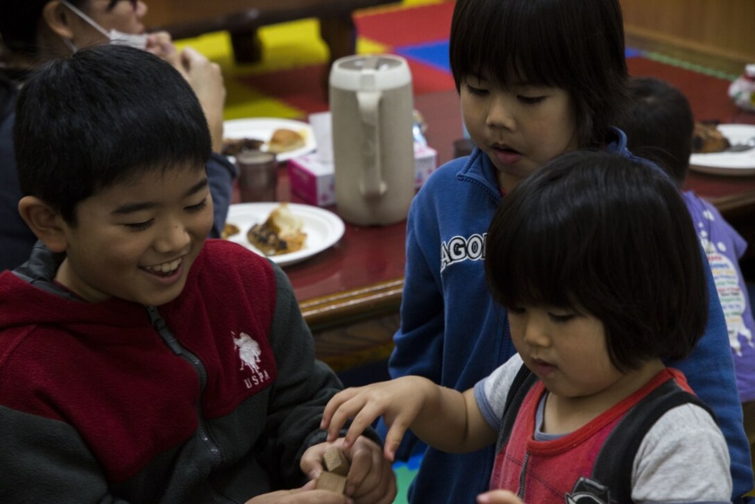 Three local Okinawan children play jenga during a community outreach event, March 3, 2017, at Yugafu Church, in Okinawa, Japan. Marines and Sailors with 3D Marine Expeditionary Brigade provided food for less fortunate children during the event. For Thanksgiving, the 3D MEB volunteers served food to 100 people at the church. (U.S. Marine Corps photo by Cpl. Samantha Villarreal/Released) 