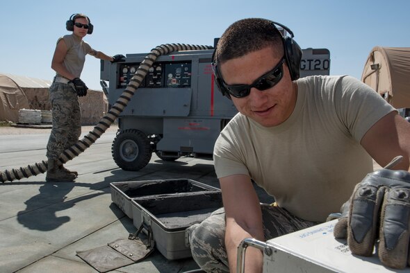 Staff Sgt. Adan Nunez and Senior Airman Melissa Jones, both 332nd Expeditionary Maintenance Group aerospace ground equipment specialists, inspect an A/M32A-60A generator, commonly referred to as a Dash 60, at the 407th Air Expeditionary Group, Feb. 27, 2017. The Airmen are deployed in support of Combined Joint Task Force - Operation Inherent Resolve.  (U.S. Air Force photo/Master Sgt. Benjamin Wilson)(Released)