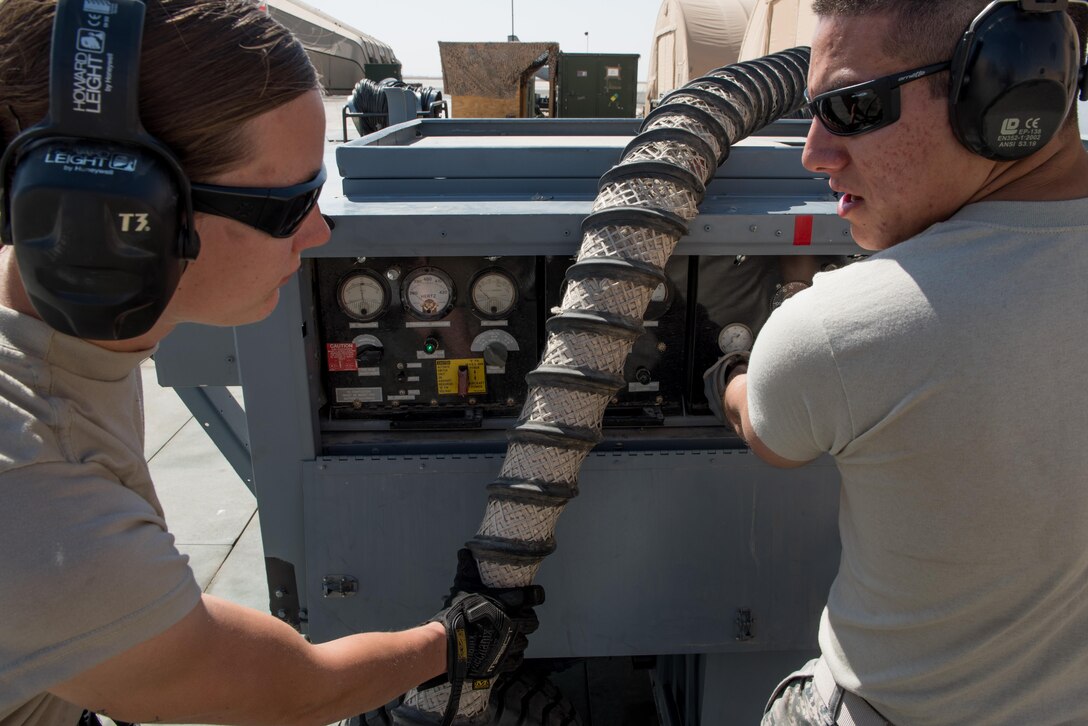 Staff Sgt. Adan Nunez and Senior Airman Melissa Jones, both 332nd Expeditionary Maintenance Group aerospace ground equipment specialists, inspect an A/M32A-60A generator, commonly referred to as a Dash 60, at the 407th Air Expeditionary Group, Feb. 27, 2017. The Dash 60 is used to provide auxiliary power to transient aircraft delivering supplies and personnel to the base. (U.S. Air Force photo/Master Sgt. Benjamin Wilson)(Released)