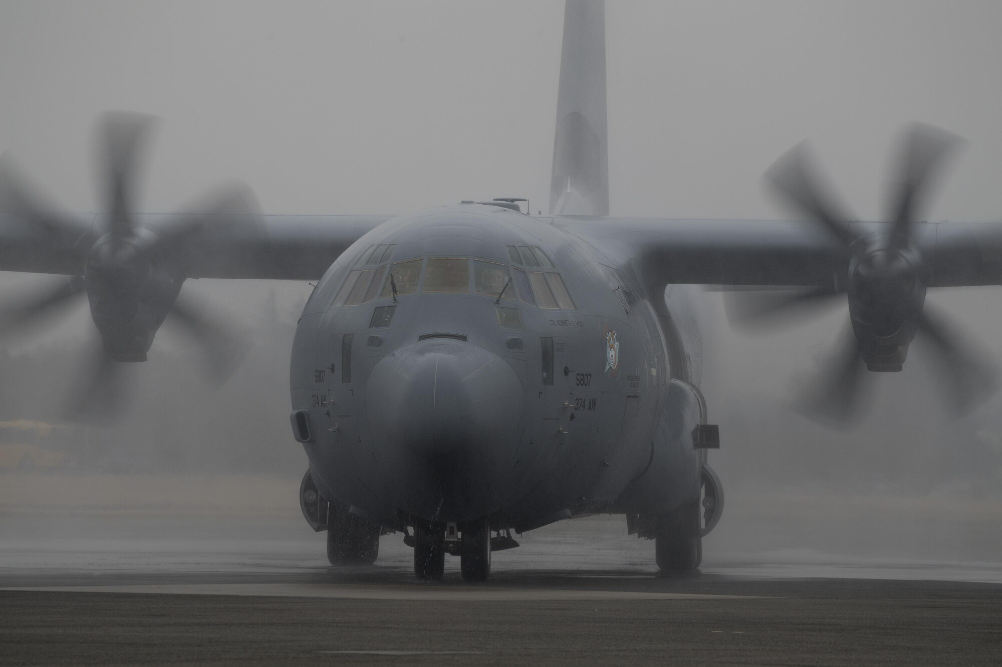 A C-130J Super Hercules with the 36th Airlift Squadron is drenched in water during a water salute upon arrival at Yokota Air Base, Japan, March 6, 2016. Much like its H-model older brother, the C-130J will be used to support critical peacekeeping and contingency operations in the Indo-Asia Pacific region, including cargo delivery, troop transport, airdrop and aeromedical missions. (U.S. Air Force photo by Staff Sgt. David Owsianka)