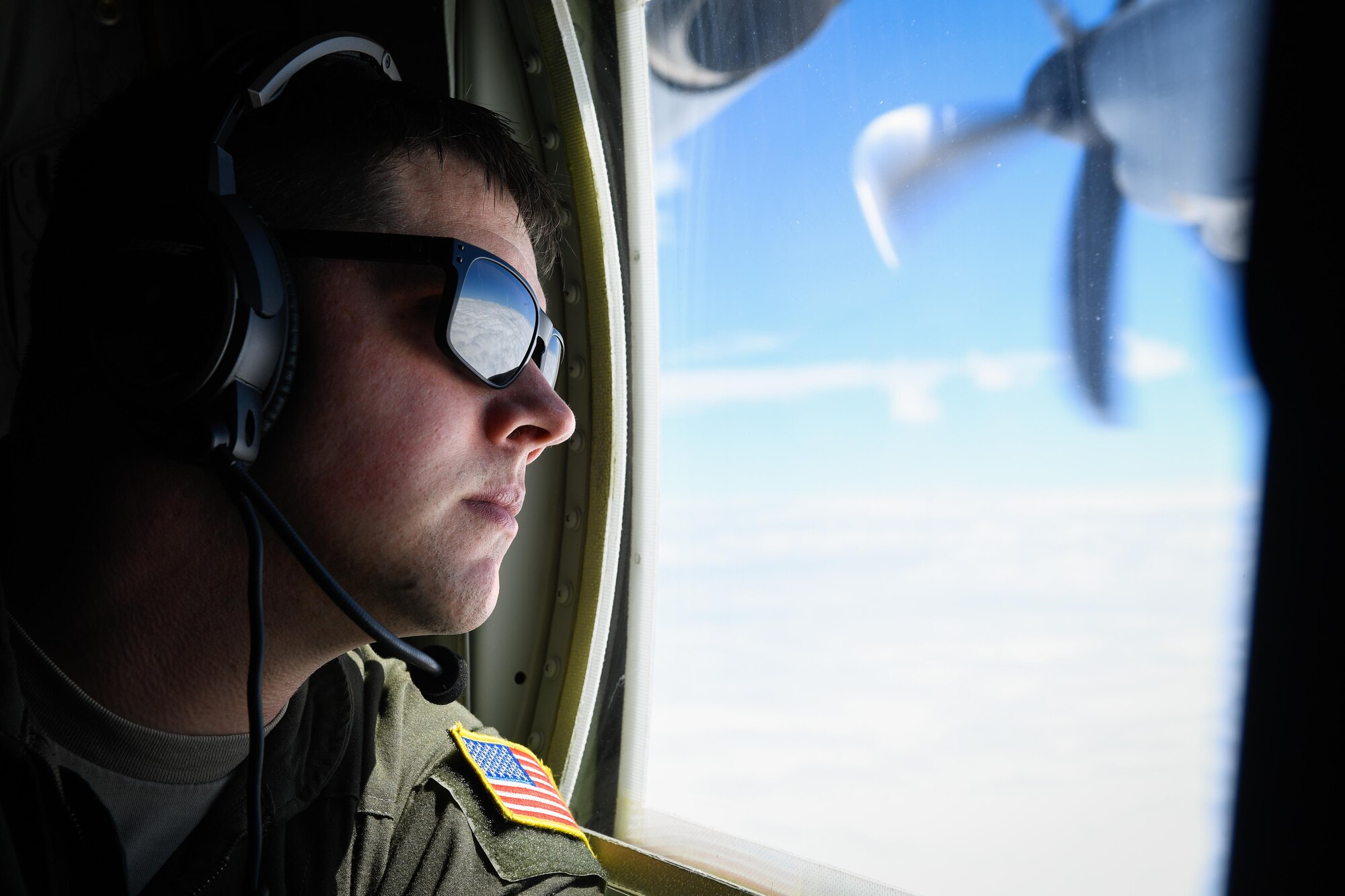 A loadmaster with the 36th Airlift Squadron, performs a visual conformation over the Pacific Ocean, March 6, 2017. This is the first C-130J to be assigned to Pacific Air Forces. Yokota serves as the primary Western Pacific airlift hub for U.S. Air Force peacetime and contingency operations. Missions include tactical air land, airdrop, aeromedical evacuation, special operations and distinguished visitor airlift. (U.S. Air Force photo by Staff Sgt. Michael Smith)