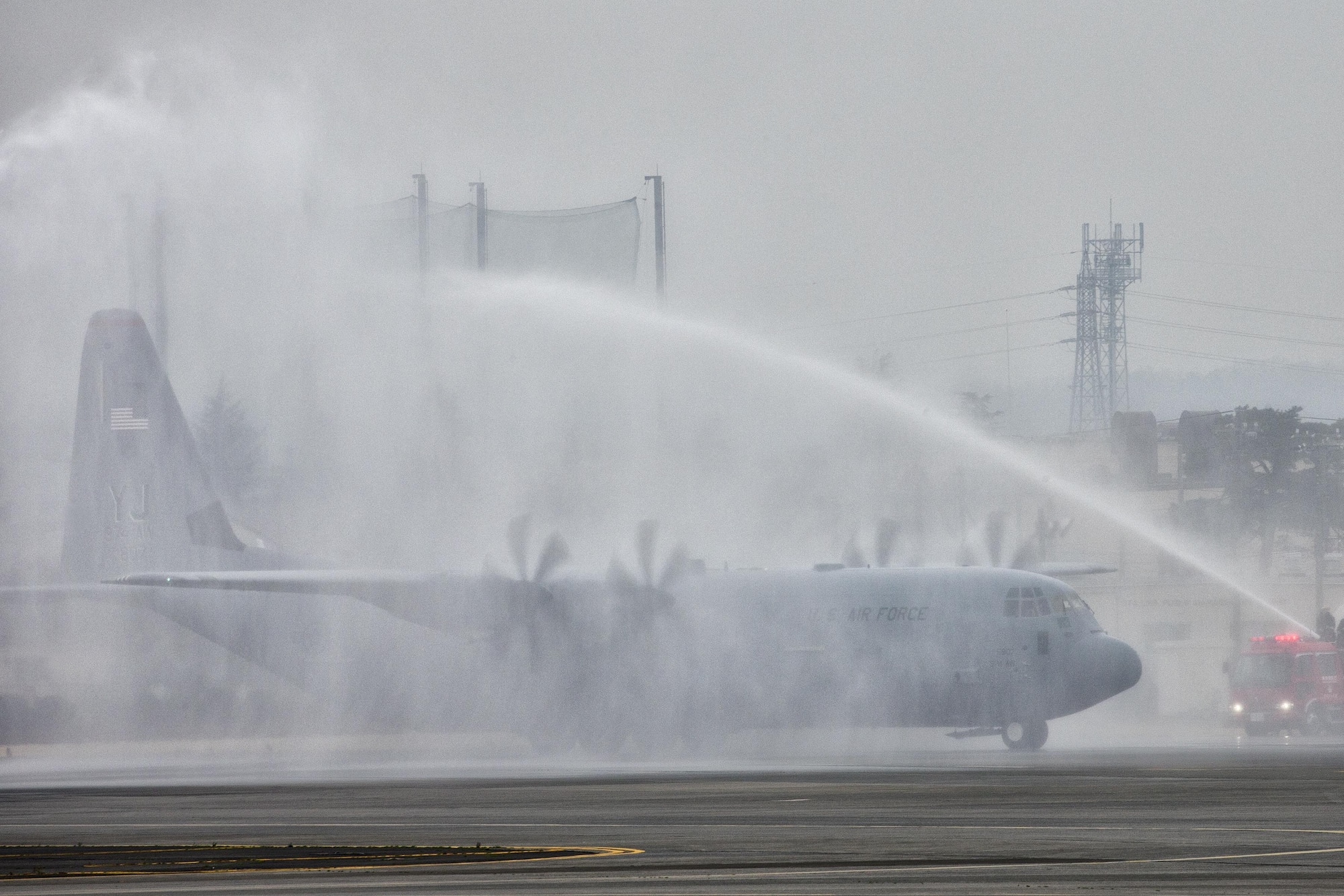 A C-130J Super Hercules gives a water salute at Yokota Air Base, Japan, March 6, 2017. This is the C-130J first Super Hercules to be stationed in the Pacific. This is the first C-130J to be assigned to Pacific Air Forces. Yokota serves as the primary Western Pacific airlift hub for U.S. Air Force peacetime and contingency operations. Missions include tactical air land, airdrop, aeromedical evacuation, special operations and distinguished visitor airlift.(U.S. Air Force photo by Yasuo Osakabe)