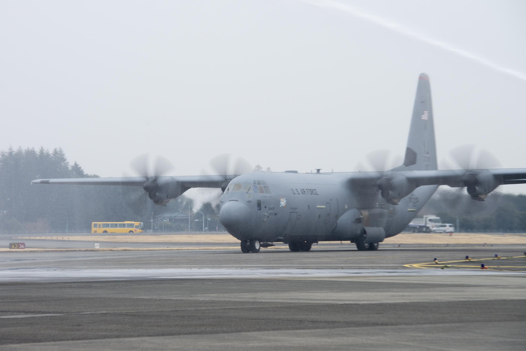 The first C-130J Super Hercules to be assigned to U.S. Pacific Air Forces taxis through a water salute at Yokota Air Base, Japan, Mar. 6, 2017. The new aircraft is scheduled to have fully replaced the 374th Airlift Wing's C-130 Hercules fleet by 2018. (U.S. Air Force photo by Senior Airman David C. Danford)