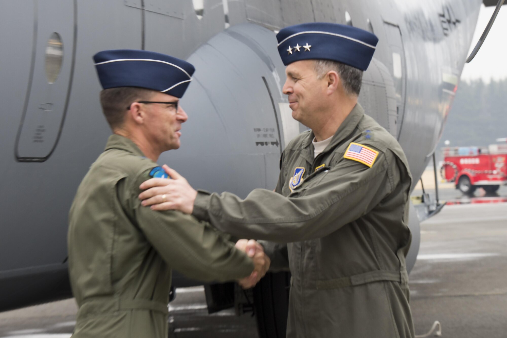 Lt. Gen. Jerry Martinez, U.S. Forces Japan and 5th Air Force commander, right, greets Maj. Gen. Mark Dillon, Pacific Air Forces vice-commander, left, during a ceremony held to celebrate the arrival of the first C-130J Super Hercules assigned to Yokota Air Base, Japan, Mar. 6, 2017. The aircraft provides significant performance improvements and added operational capabilities that translate directly into increased effectiveness. (U.S. Air Force photo by Senior Airman David C. Danford)