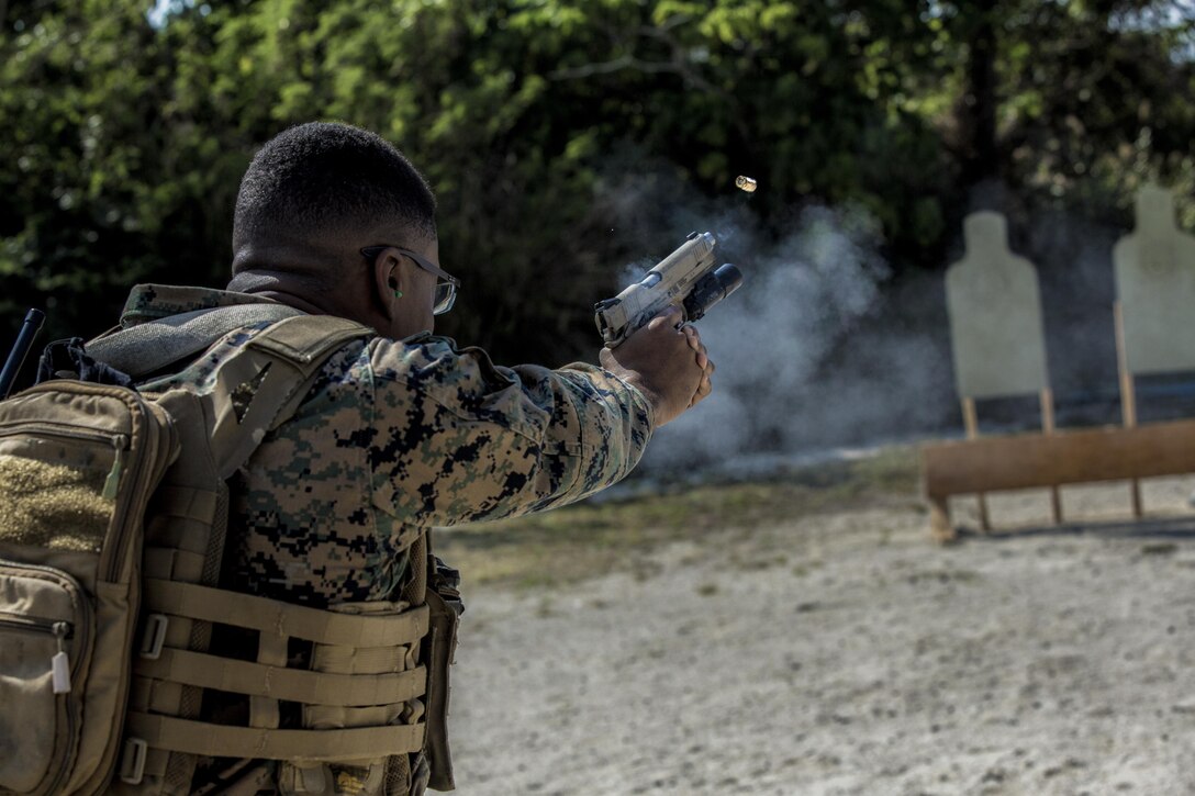 Cpl. Jona R. Meme, a combat camera Marine with the 31st Marine Expeditionary Unit, fires a M45A1 pistol during a range at Camp Hansen, Okinawa, Japan Feb. 27, 2017. As the Marine Corps' only continuously forward-deployed unit, the 31st Marine Expeditionary Unit's air-ground-logistics team range of military operations, from limited combat to humanitarian assistance operations, throughout the Indo-Asia-Pacific region. 