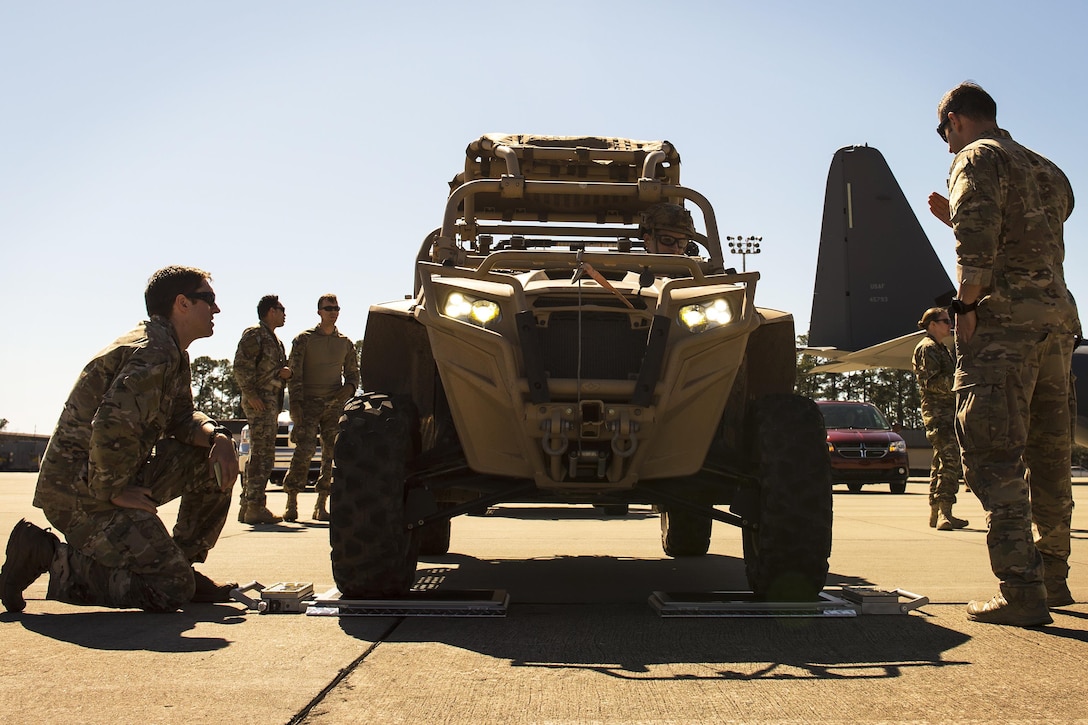 Airmen check the weight of a Polaris MRZR light tactical all-terrain vehicle during static load training as part of the Emerald Warrior 17 exercise at Hurlburt Field, Fla., Feb. 26, 2017. Air Force photo by Senior Airman Erin Piazza