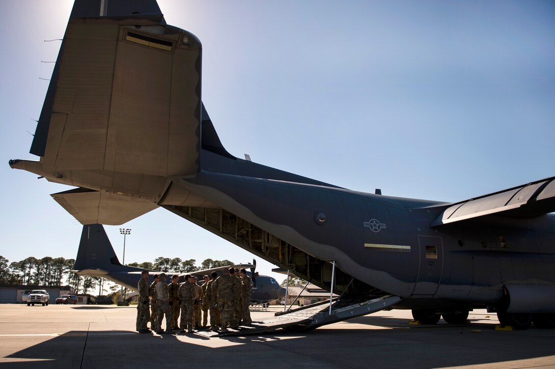 Airmen receive a mission brief near the tail of an MC-130J Commando II aircraft during static load training as part of the Emerald Warrior 17 exercise at Hurlburt Field, Fla., Feb. 26, 2017. Air Force photo by Senior Airman Erin Piazza