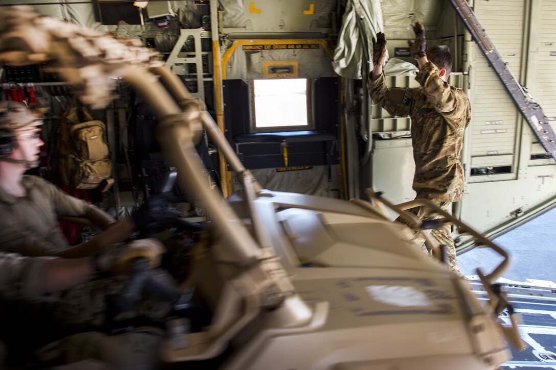 An airman directs the driver of a Polaris MRZR light tactical all-terrain vehicle as he exits an MC-130J Commando II aircraft during static load training as part of the Emerald Warrior 17 exercise at Hurlburt Field, Fla., Feb. 26, 2017. Air Force photo by Senior Airman Erin Piazza