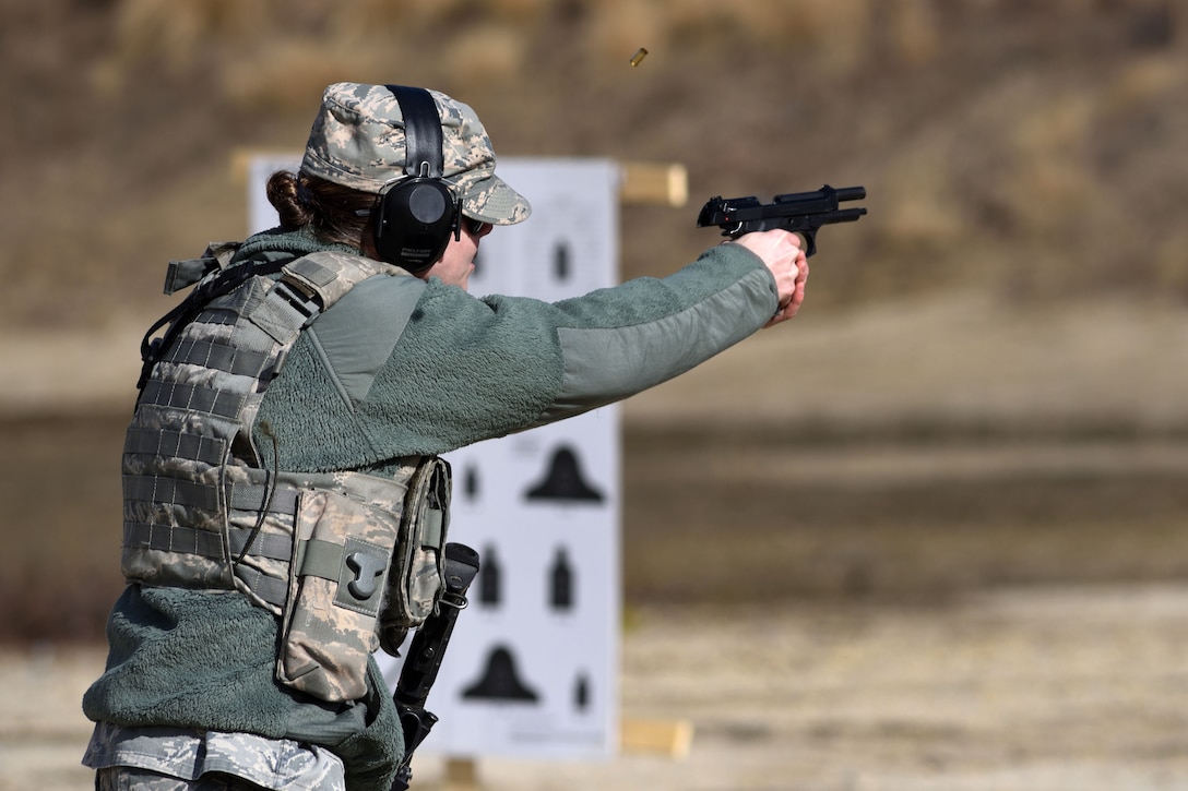 New Jersey Air National Guard Staff Sgt. Laura Lemay fires M9 pistol ejecting a spent casing during range qualification at Joint Base McGuire-Dix-Lakehurst, New Jersey, Feb. 26, 2017. Lemay is assigned to the 108th Security Forces Squadron. New Jersey Air National Guard photo by Senior Airman Julia Santiago