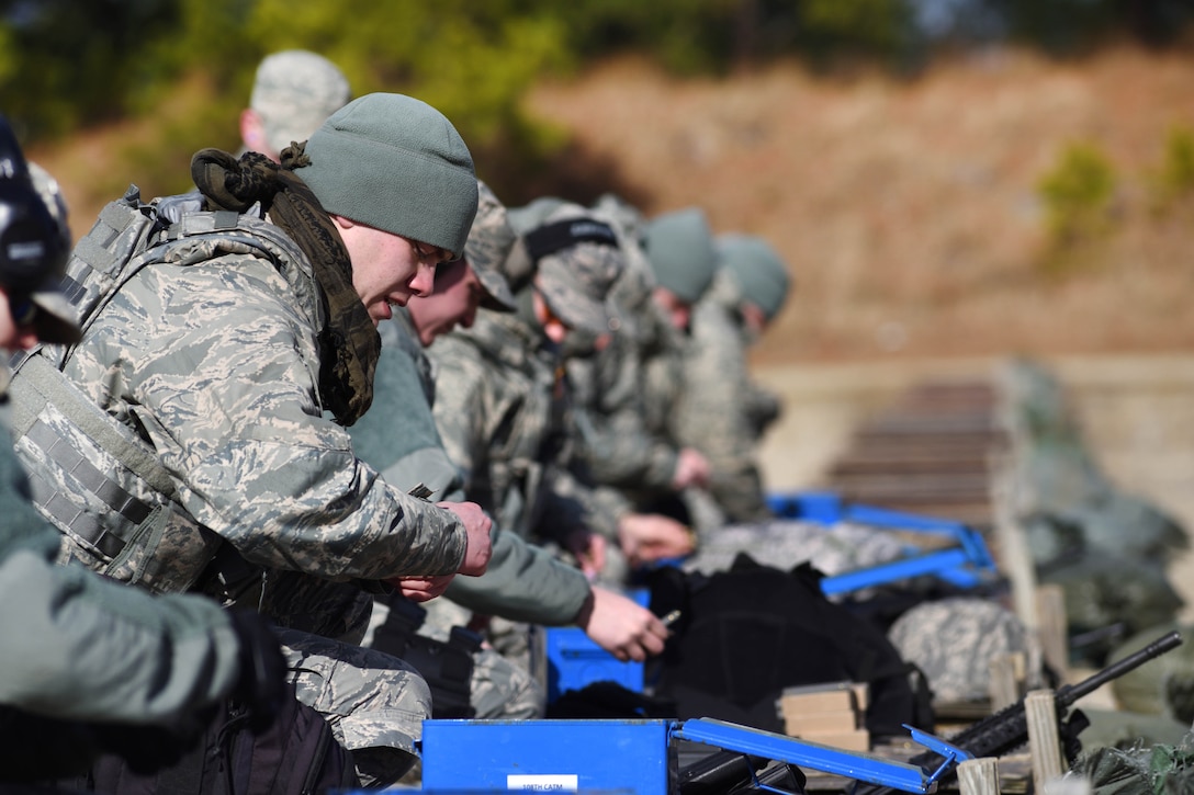 New Jersey Air National Guard Airman 1st Class Peter Sampe removes ammunition from its packaging before loading it into a magazine for use during range qualification at Joint Base McGuire-Dix-Lakehurst, New Jersey, Feb. 26, 2017. Sampe is assigned to the 108th Security Forces Squadron. New Jersey Air National Guard photo by Senior Airman Julia Santiago