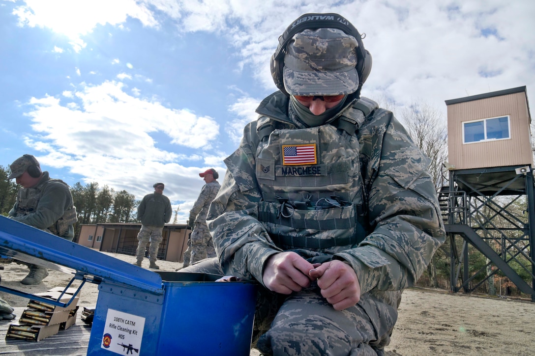 New Jersey Air National Guard Staff Sgt. Jennifer Marchese removes M4 ammunition from a stripper clip as she prepares to load a magazine during range qualification at Joint Base McGuire-Dix-Lakehurst, New Jersey, Feb. 26, 2017. Marchese is assigned to the 108th Security Forces Squadron. New Jersey Air National Guard photo by Staff Sgt. Ross A. Whitley