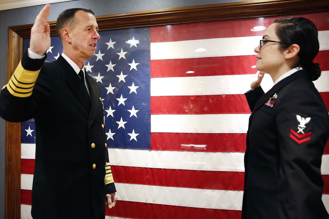 Chief of Naval Operations Adm. John Richardson, left, re-enlists Petty Officer 2nd Class Samantha Kaehler aboard the future USS Gerald R. Ford in Newport News, Va., March 2, 2017. Kaehler is a cryptologic technician. Navy photo by Petty Officer 3rd Class Matthew R. Fairchild