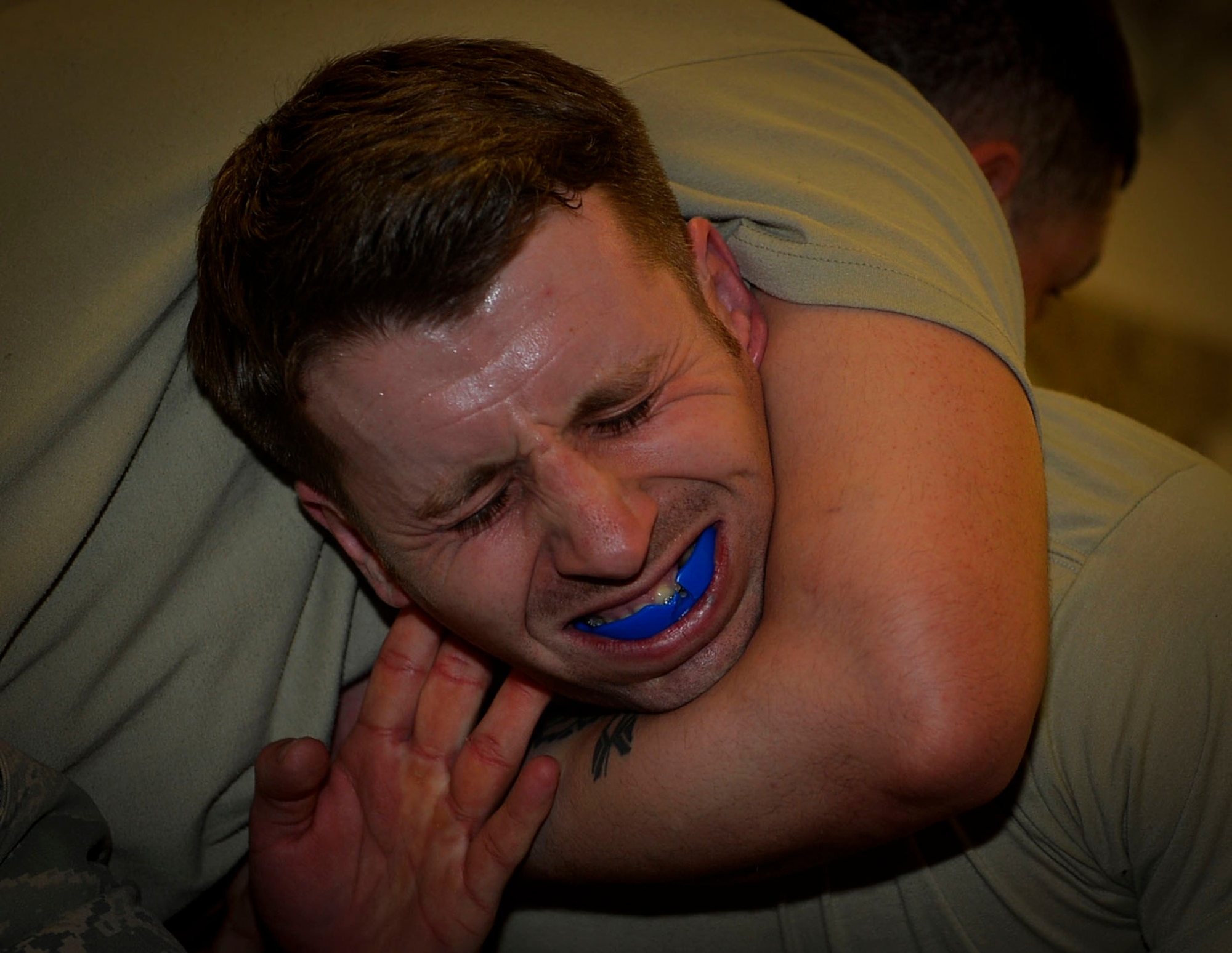 Tech. Sgt. Kevin Robinson, 86th Security Forces Squadron NCO in charge of reports and analysis, gets locked in a guillotine choke during a combatives class on Ramstein Air Base, Germany, March 2, 2017. Airmen from the 86th SFS and 569th U.S. Forces Police Squadron participated in the Fly Away Security Training program to prepare for scenarios they may face while on a mission. The 10-day program is managed by the 435th SFS and caters to Airmen providing security for aircraft. (U.S. Air Force photo by Airman 1st Class Joshua Magbanua)