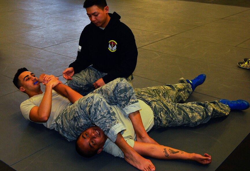 Staff Sgt. Jesse Sengsouk, 435th Security Forces Squadron ground combat readiness training center instructor, teaches security forces Airmen how to perform an arm bar submission during a combatives course on Ramstein Air Base, Germany, March 2, 2017. Instructors with the 435th SFS conduct the Fly Away Security Training program to prepare security forces Airmen, particularly from the 86gh SFS and 569th U.S. Forces Police Squadron, for scenarios they may face while on a mission. The 10-day course includes various submission techniques, baton training, and weapons disarmament. (U.S. Air Force photo by Airman 1st Class Joshua Magbanua)