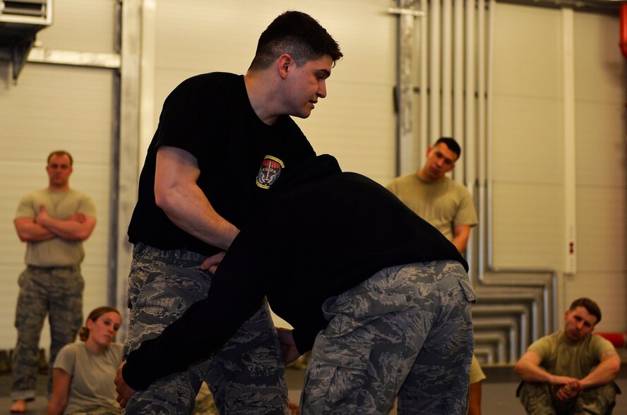 Staff Sgt. Jose Ruiz, 435th Security Forces Squadron ground combat readiness training center instructor, left, conducts a combatives class for Airmen from the 86th Security Forces Squadron and 569th U.S. Forces Police Squadron, on Ramstein Air Base, Germany, March 2, 2017. The 435th SFS conducts the Fly Away Security Training program for Airmen providing security for aircraft. FAST instructors aim to help prepare security forces Airmen for scenarios they may face while on a mission. (U.S. Air Force photo by Airman 1st Class Joshua Magbanua)