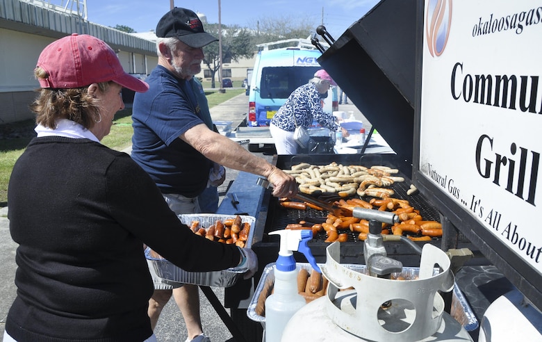 Crestview Military Affairs members cook up some brats for lunch prior to the kick off of the 919th Special Operations Wing’s annual Wing Day March 4 at Duke Field, Fla.  The wing sets aside a special day each year to show appreciation for its reservists and their family members. Events included music, food, children’s games, etc. (U.S. Air Force photo/Dan Neely)