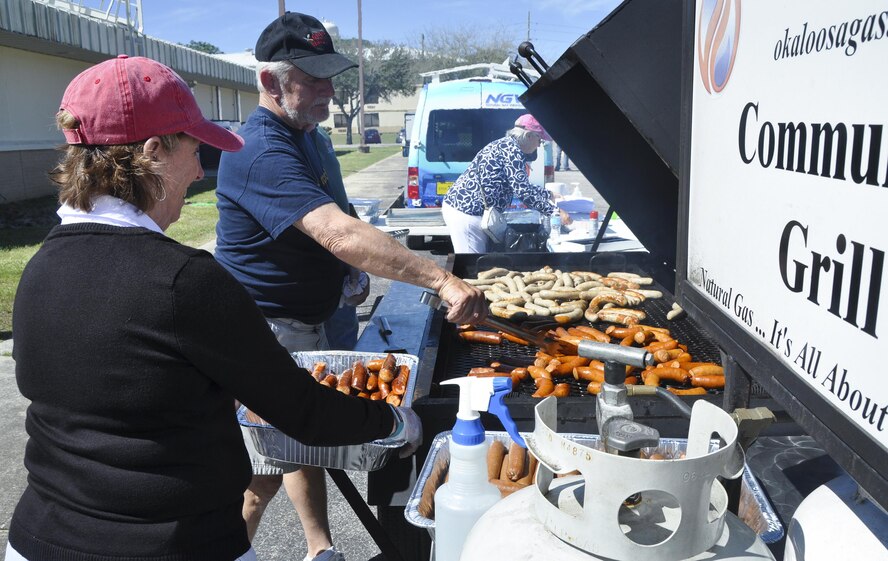 Crestview Military Affairs members cook up some brats for lunch prior to the kick off of the 919th Special Operations Wing’s annual Wing Day March 4 at Duke Field, Fla.  The wing sets aside a special day each year to show appreciation for its reservists and their family members. Events included music, food, children’s games, etc. (U.S. Air Force photo/Dan Neely)