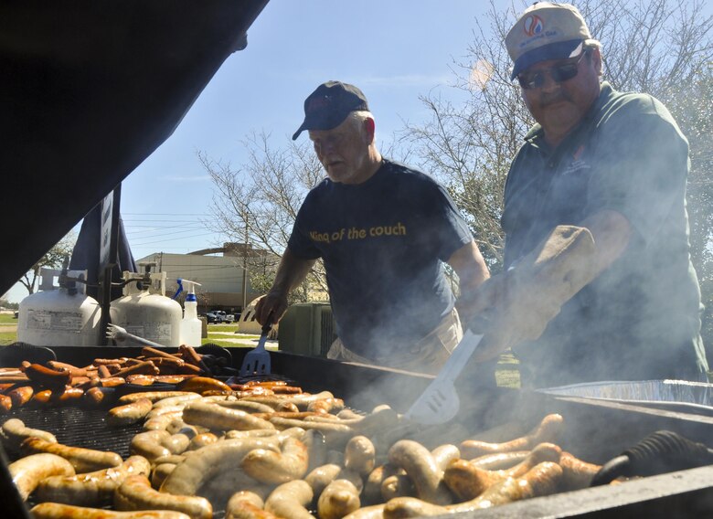 Crestview Military Affairs members cook up some brats for lunch prior to the kick off of the 919th Special Operations Wing’s annual Wing Day March 4 at Duke Field, Fla.  The wing sets aside a special day each year to show appreciation for its reservists and their family members. Events included music, food, children’s games, etc. (U.S. Air Force photo/Dan Neely)