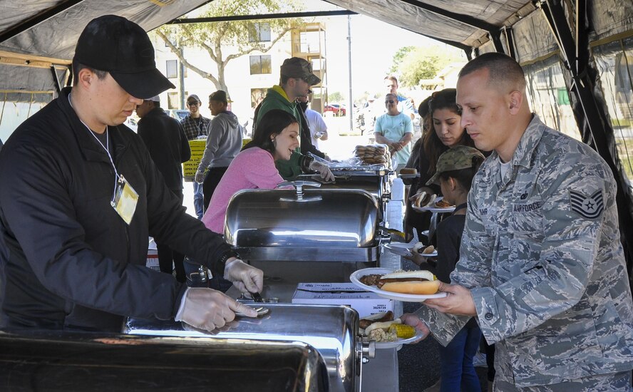 Tech. Sgt. Chris Kuhr, 919th Special Operations Support Squadron, carries two plates for himself and his family during the 919th Special Operations Wing’s annual Wing Day March 4 at Duke Field, Fla.  The wing sets aside a special day each year to show appreciation for its reservists and their family members. Events included music, food, children’s games, etc. (U.S. Air Force photo/Dan Neely)