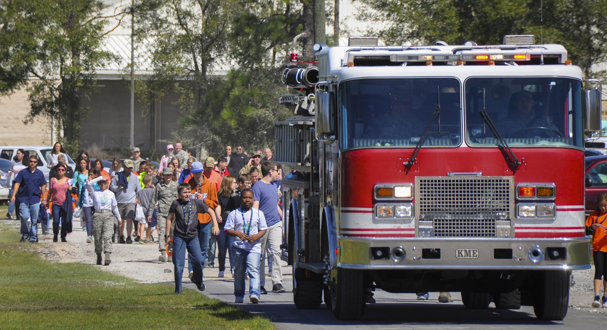 A fire truck leads the Operation Hero kid deployers to the 919th Special Operations Wing’s annual Wing Day March 4 at Duke Field, Fla.  The Operation Hero event took place just prior to the Wing Day event.  The wing sets aside a special day each year to show appreciation for its reservists and their family members. Events included music, food, children’s games, etc. (U.S. Air Force photo/Dan Neely)