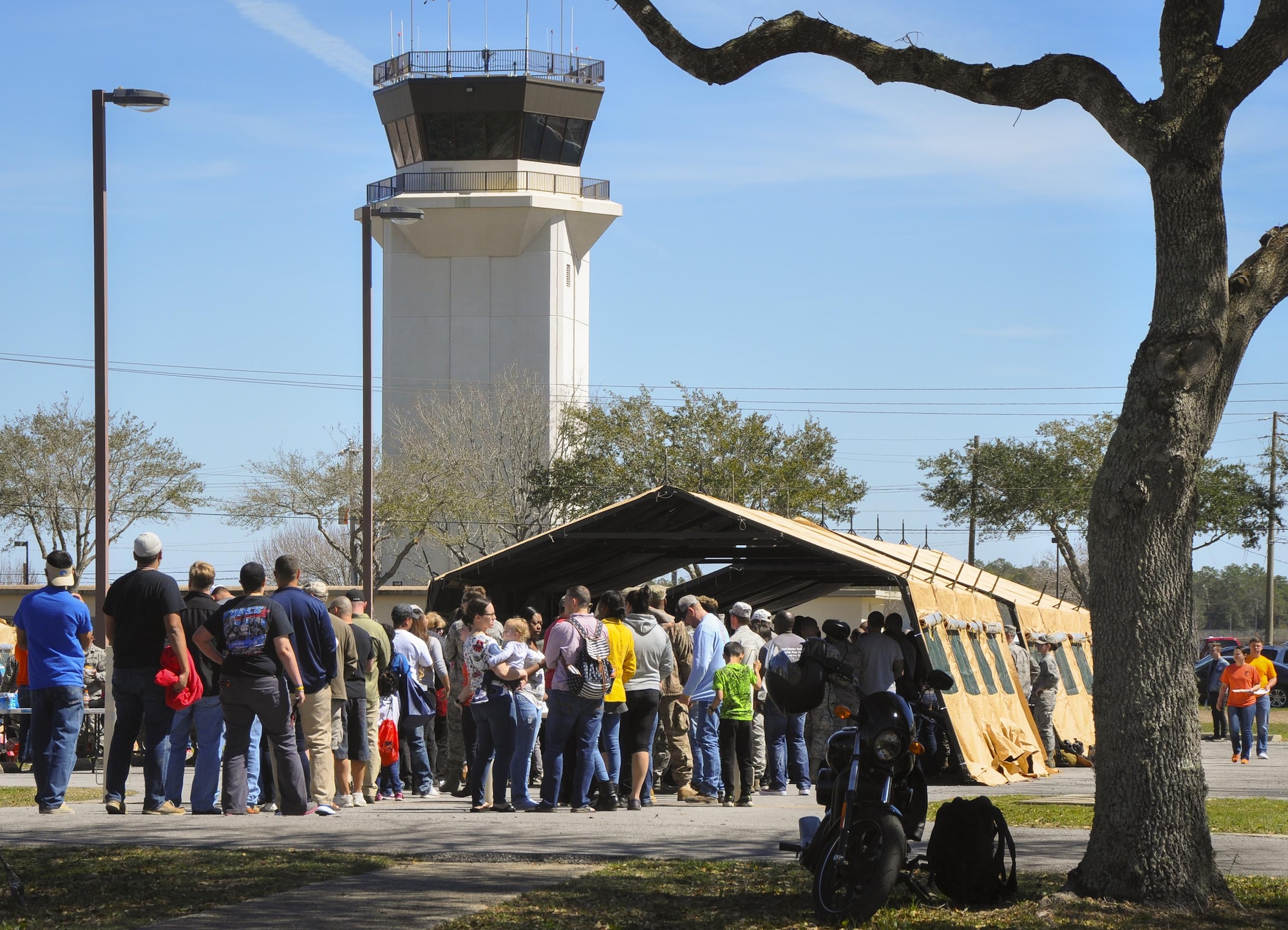 Lines form at the food tent at the beginning of the 919th Special Operations Wing’s annual Wing Day March 4 at Duke Field, Fla.  The wing sets aside a special day each year to show appreciation for its reservists and their family members. Events included music, food, children’s games, etc. (U.S. Air Force photo/Dan Neely)