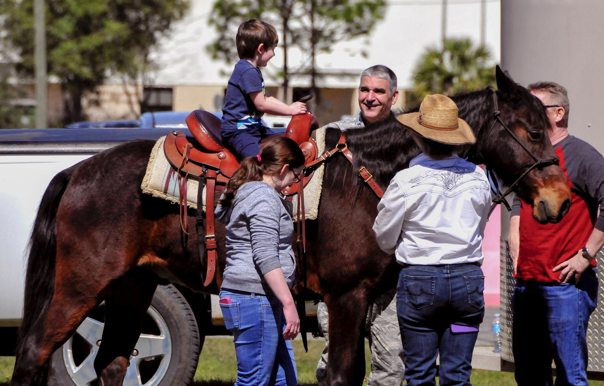 Col. James Phillips, the 919th Special Operations Wing commander, greets a family member during a pony ride at the unit’s annual Wing Day March 4 at Duke Field, Fla.  The wing sets aside a special day each year to show appreciation for its reservists and their family members. Events included music, food, children’s games, etc. (U.S. Air Force photo/Tech. Sgt. Kimberly Moore)