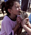 A little princess leans in for a frog smooch at the 919th Special Operations Wing’s annual Wing Day March 4 at Duke Field, Fla.  The wing sets aside a special day each year to show appreciation for its reservists and their family members. Events included music, food, children’s games, etc. (U.S. Air Force photo/Tech. Sgt. Kimberly Moore)