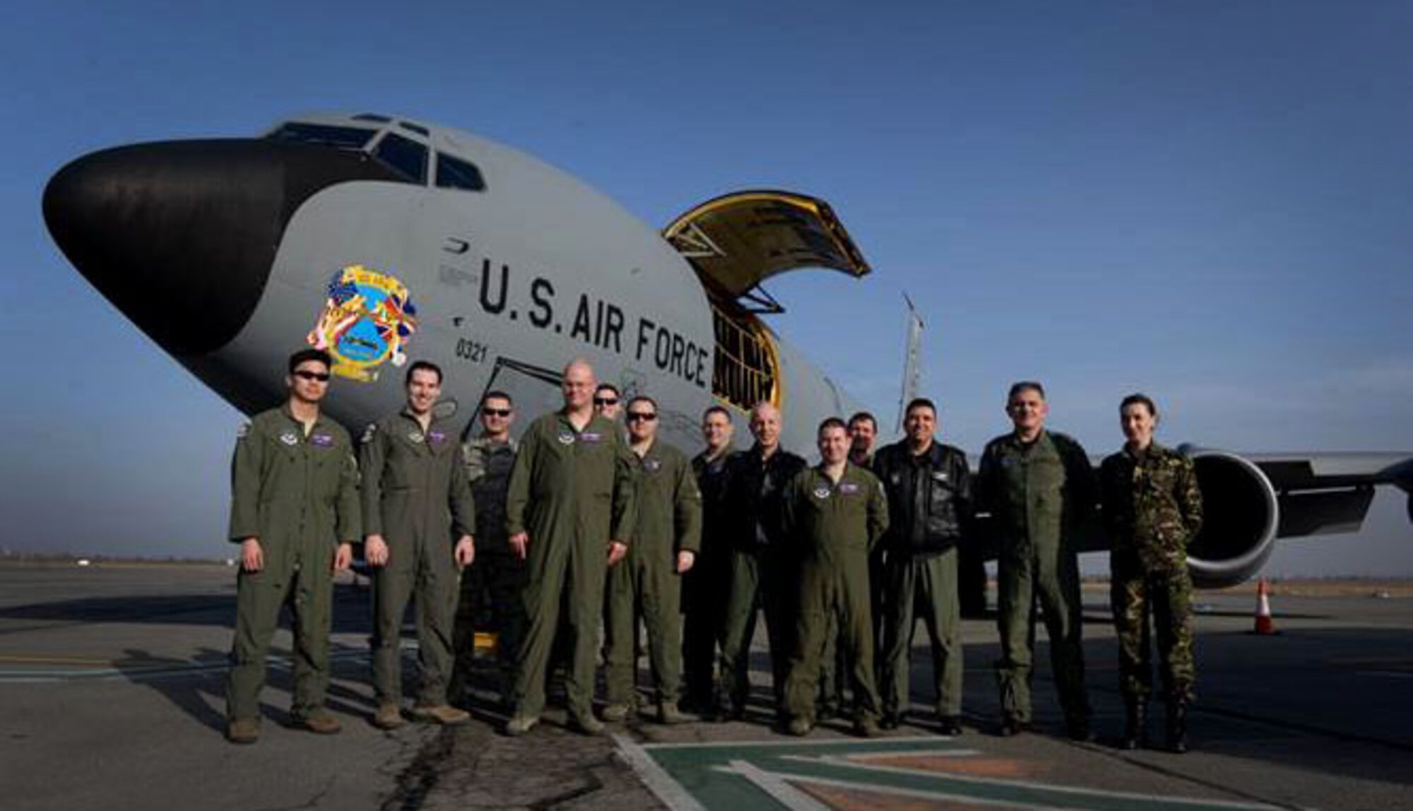 U.S. Air Force and Romanian air force Airmen pose for a photo after a flight Feb. 28, 2017, during air refueling training over Bucharest, Romania. The RoAF F-16 Fighting Falcons made their first contact with a U.S. tanker during the flight as part of air refueling training and certification conducted by the 100th Air Refueling Wing from RAF Mildenhall, England. (U.S. Air Force photo by Staff Sgt. Kate Thornton)