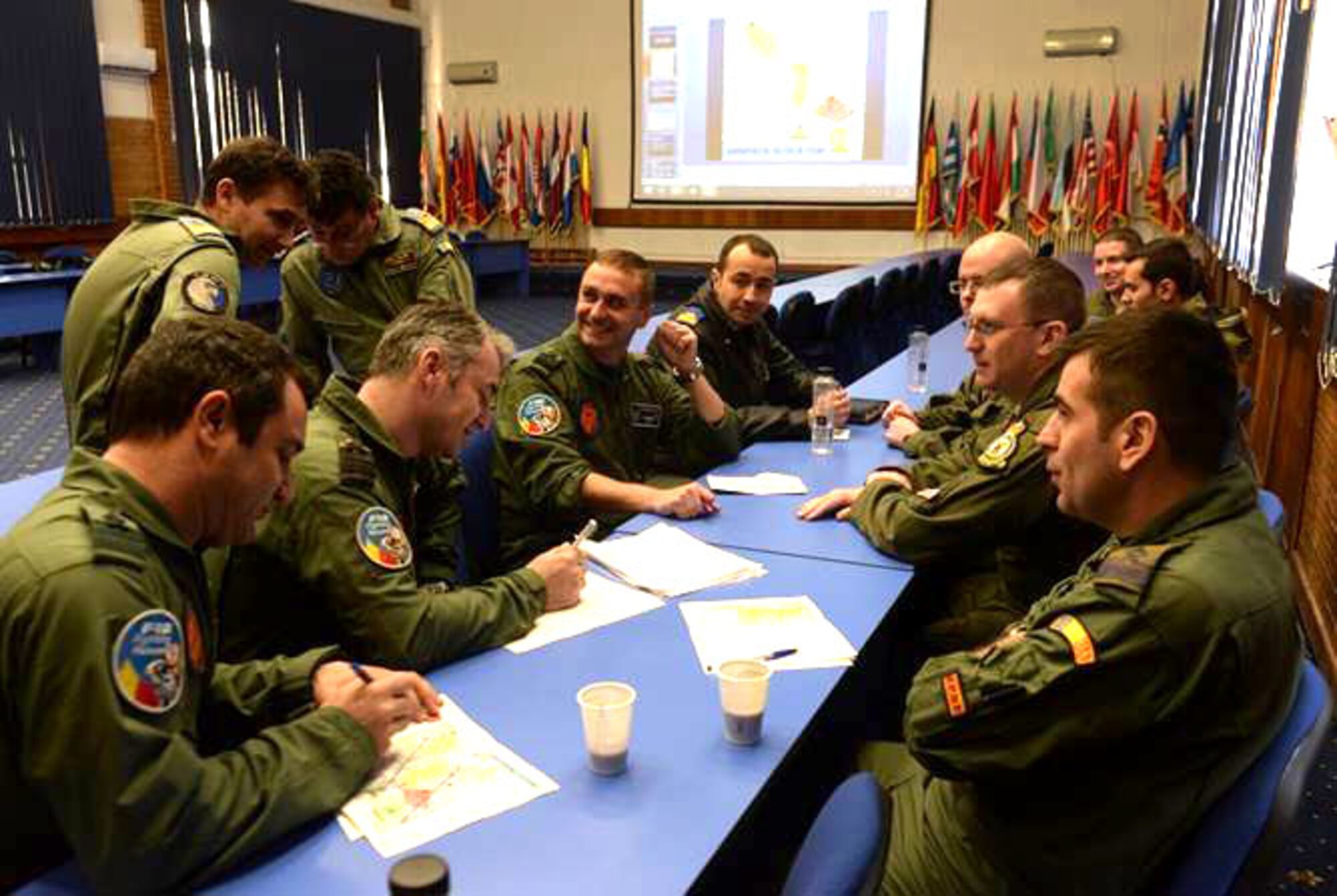 Aircrew from the U.S. Air Force and the Romanian air force discuss flight plans during the first air refueling training between the two countries Feb. 27, 2017, in Bucharest, Romania. The crew from the 100th Air Refueling Wing from RAF Mildenhall, England, travelled to Bucharest to train and certify the RoAF F-16 Fighting Falcon fleet on air refueling with a U.S. tanker. (U.S. Air Force photo by Staff Sgt. Kate Thornton)