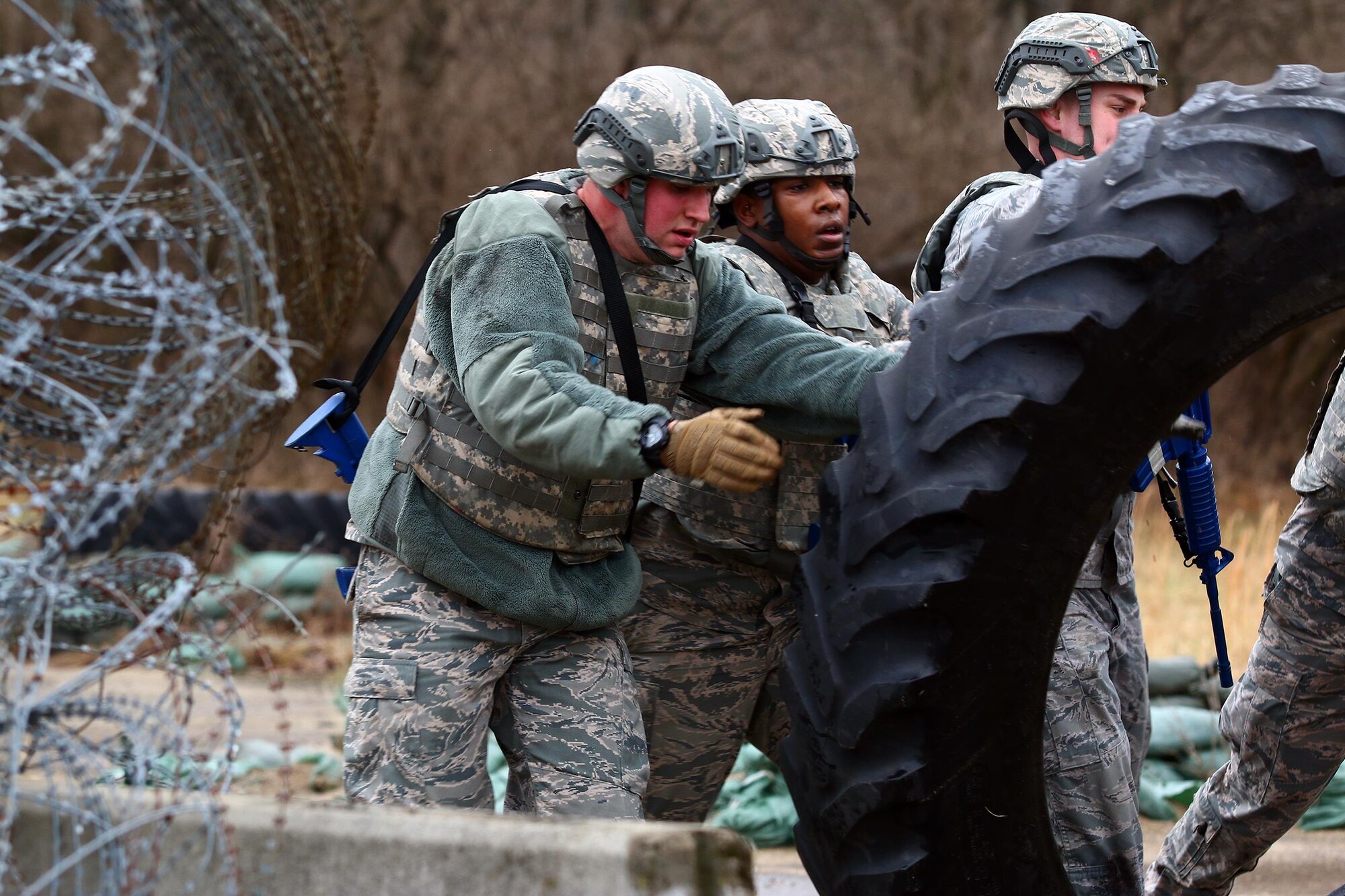 Members of the 445th Security Forces Squadron endure the ‘Winter Challenge’ here Feb. 12, 2017.  The challenge is designed to provide an experience during inclement weather. The event consisted of several stages to include: vehicle inspections, ammo carries, MOUT (military operations in urban terrain), rolling a large tire and pushing a Humvee more than 200 feet.  (U.S. Air Force photo /Tech. Sgt. Patrick O’Reilly)