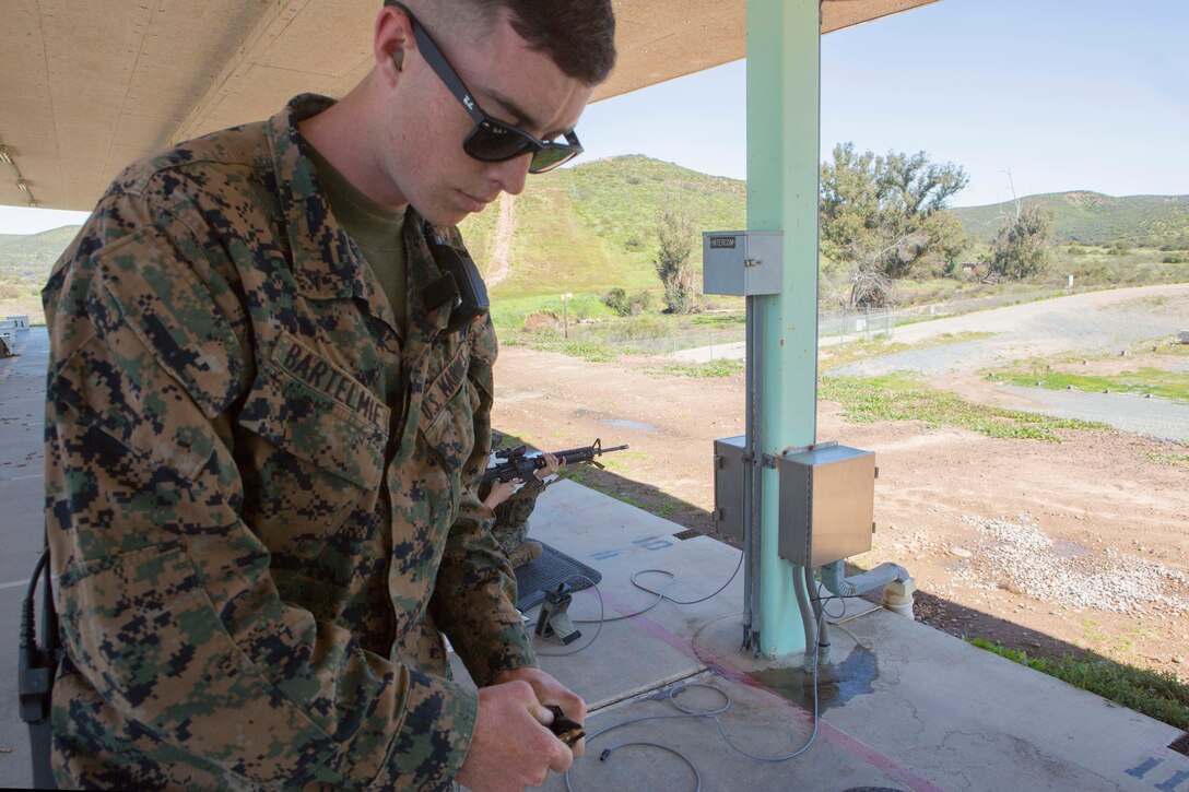 Lance Cpl. Anthony Bartelmie, the Hathcock Range armorer, attempts to fix a magazine double feed, during rifle qualifications the Carlos Hathcock Range Complex at Marine Corps Air Station Miramar, Calif., March 1. As the range armorer, Bartelmie is responsible for assisting with weapons malfunctions while Marines are on the range. (U.S. Marine Corps photo by Lance Cpl. Liah Kitchen/Released)