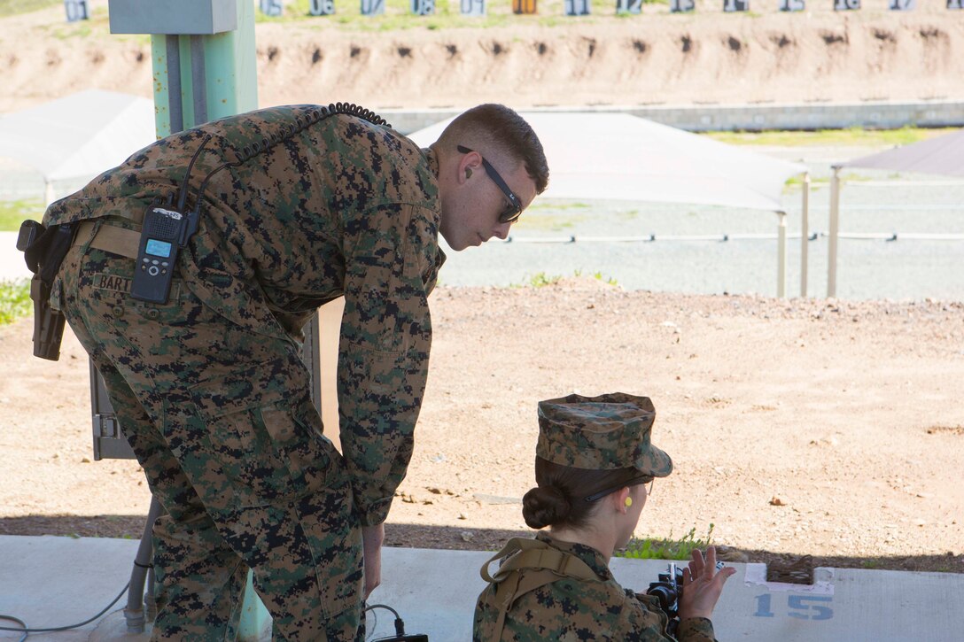 Lance Cpl. Anthony Bartelmie, left, the Hathcock Range armorer, examines a shooter’s possible weapon malfunction during rifle qualifications at the Carlos Hathcock Range Complex at Marine Corps Air Station Miramar, Calif., March 1. As the range armorer, Bartelmie is responsible for assisting with weapons malfunctions while Marines are on the range. (U.S. Marine Corps photo by Lance Cpl. Liah Kitchen/Released)