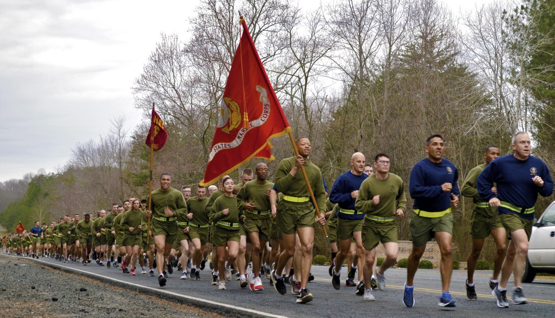 (Right) Marine Corps Embassy Security Group (MCESG) Commanding Officer Col. Rollin D. Brewster and (left) MCESG Sgt. Maj. Juan C. Alvarado lead the pack as the Marines finish the home stretch of their 3-mile motivational run before graduation.