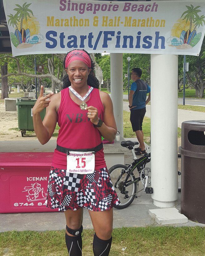 Enjoying a little bit of sunshine, Shalisa Davis stands in front of the start/finish in Singapore Beach, Singapore after finishing lucky number two.