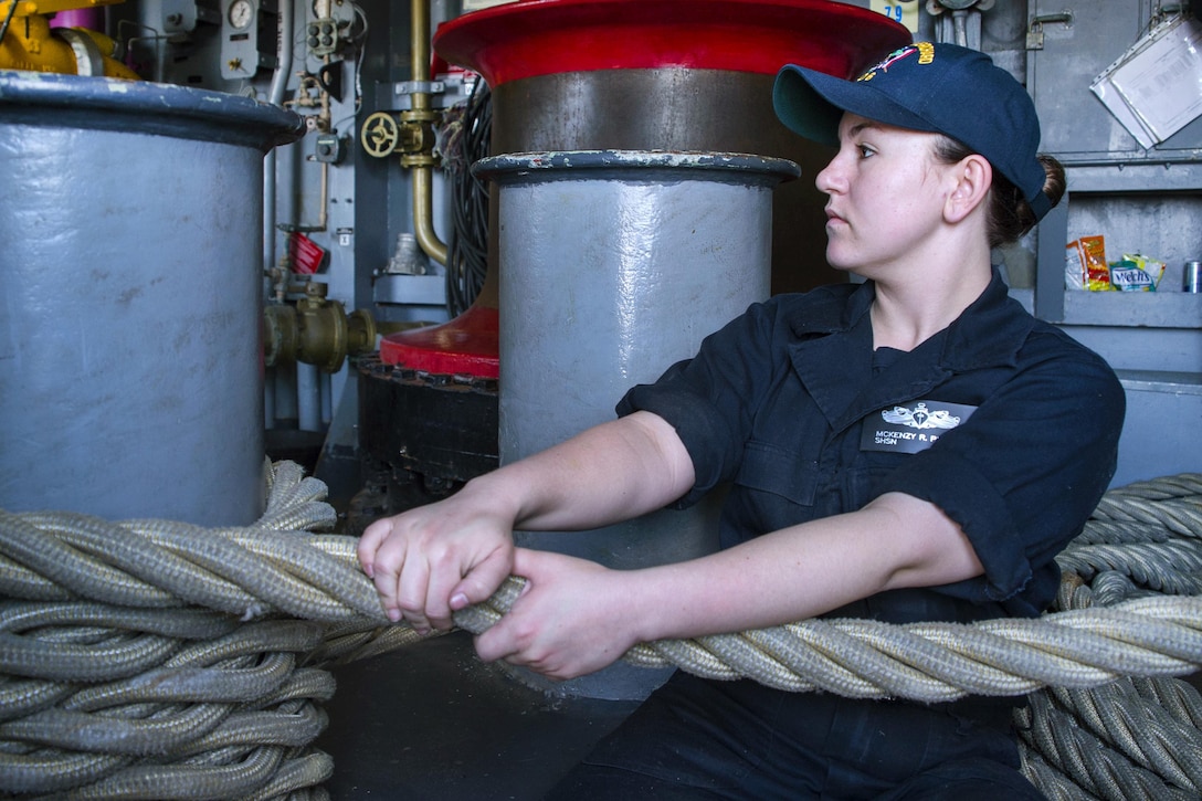 Navy Seaman Mckenzy Pickett heaves a mooring line during sea and anchor detail aboard the USS Bonhomme Richard at sea, March 4, 2017. Navy photo by Petty Officer 3rd Class Jeanette Mullinax