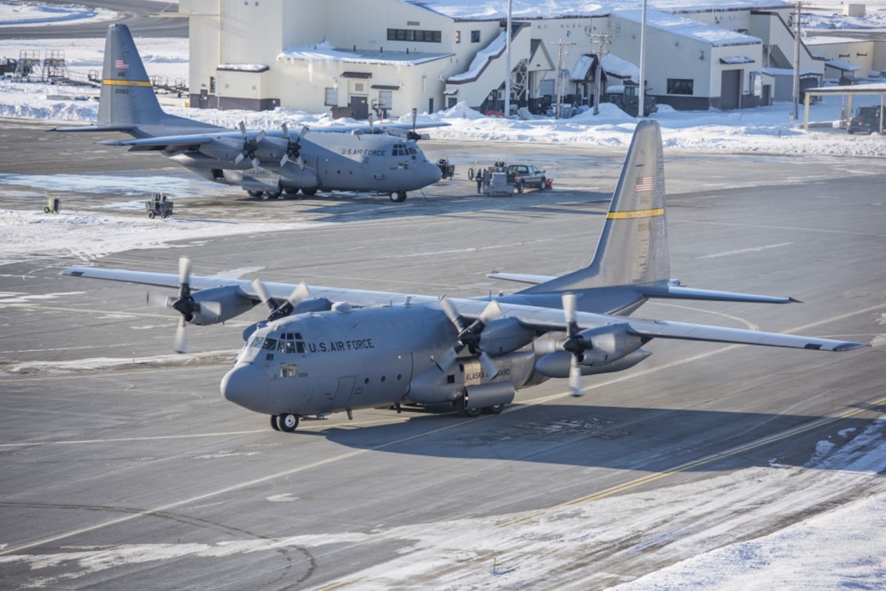 The last two C-130 Hercules aircraft from the Alaska Air National Guard's 144th Airlift Squadron prepare to take off for the last time from Joint Base Elmendorf-Richardson, Alaska, March 5, 2017. After 41 years of flying the C-130 aircraft, the 144th Airlift Squadron’s eight C-130s were divested, with the planes either being transferred to outside units or retired from service. Air National Guard photo by Staff Sgt. Edward Eagerton