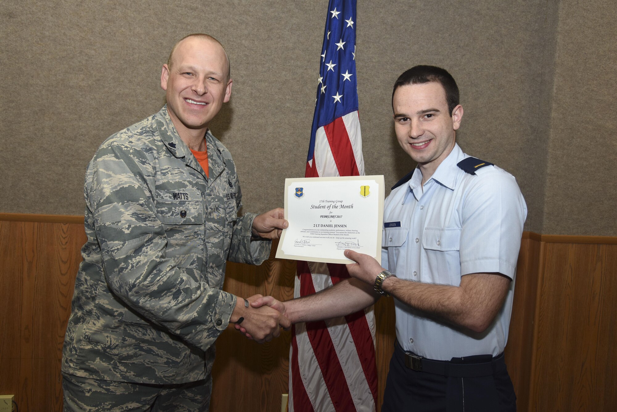 U.S. Air Force Lt. Col. Steven Watts, 17th Training Group deputy commander, presents the 315th Officer Training Squadron Student of the Month award for Febuary 2017 to 2nd Lt. Daniel Jensen, 315th TRS student, in the Brandenburg Hall on Goodfellow Air Force Base, Texas, March 3, 2017. (U.S. Air Force photo by Airman 1st Class Chase Sousa/Released)